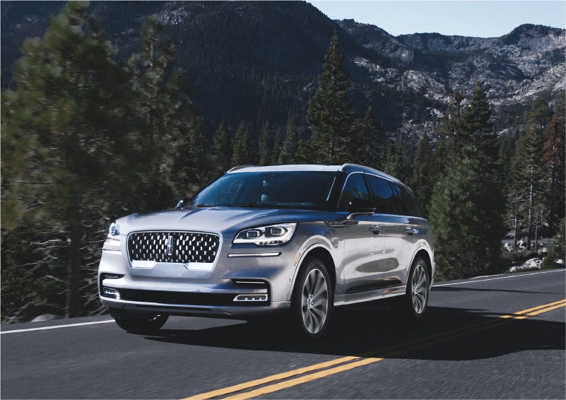 A 2023 Lincoln Aviator® Grand Touring SUV being driven on a winding road to demonstrate the capabilities of all-wheel drive | Northgate Lincoln in Port Huron MI