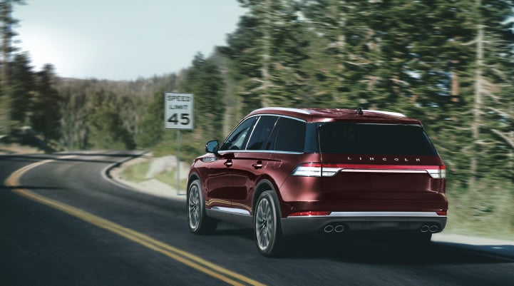 A 2024 Lincoln Aviator® SUV is being driven on a winding mountain road | Northgate Lincoln in Port Huron MI