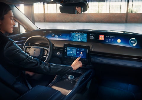 The driver of a 2024 Lincoln Nautilus® SUV interacts with the center touchscreen. | Northgate Lincoln in Port Huron MI