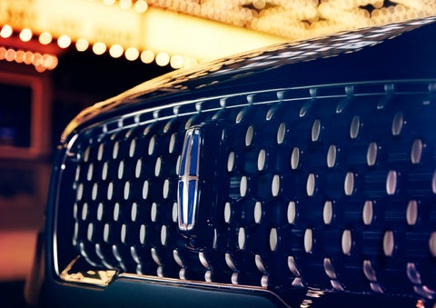 The Corsair Grand Touring grille shows floating chrome ovals that catch the glowing light of a theater marquee and frame the distinctive Lincoln Star | Northgate Lincoln in Port Huron MI