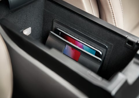 A smartphone device is securely tucked into the available wireless charging pad for an effortless energy boost | Northgate Lincoln in Port Huron MI
