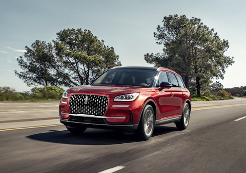A 2024 Lincoln Corsair® SUV is shown being driven on a country road. | Northgate Lincoln in Port Huron MI