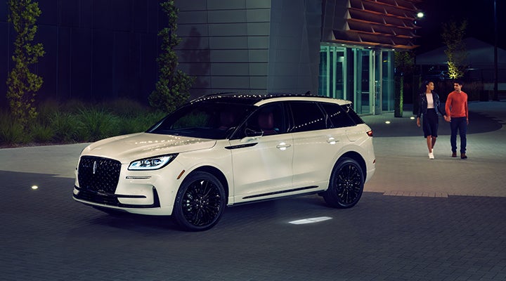 Two people approach a 2024 Lincoln Corsair® SUV featuring the available Jet Appearance Package. | Northgate Lincoln in Port Huron MI