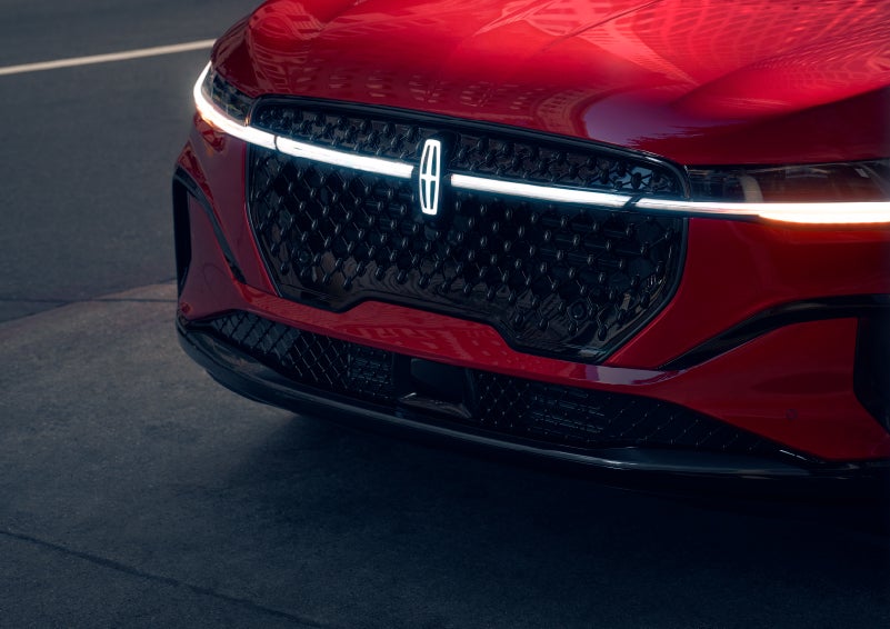 The available front LED light bar and center Lincoln Star logo glow at dusk. | Northgate Lincoln in Port Huron MI