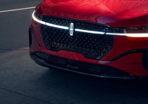 The available front LED light bar and center Lincoln Star logo glow at dusk. | Northgate Lincoln in Port Huron MI