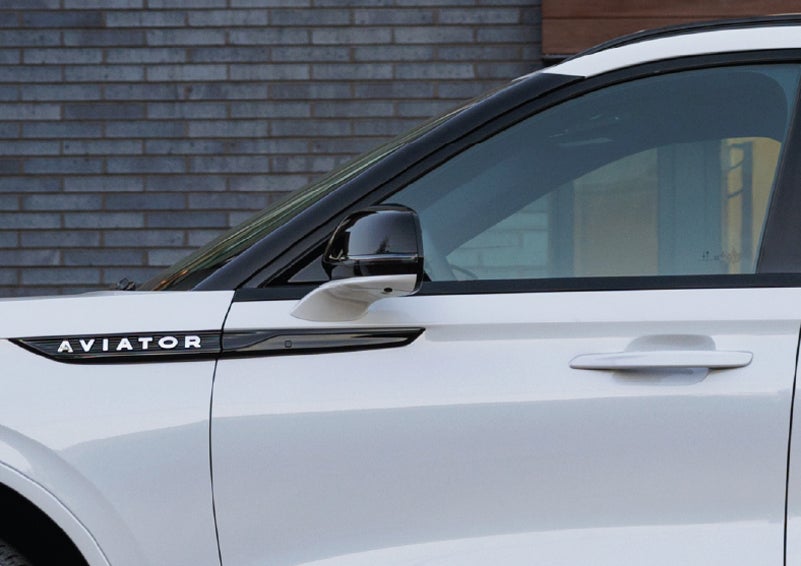 The driver’s side door and fender badging of a white 2026 Lincoln Aviator® SUV are showcased. | Northgate Lincoln in Port Huron MI