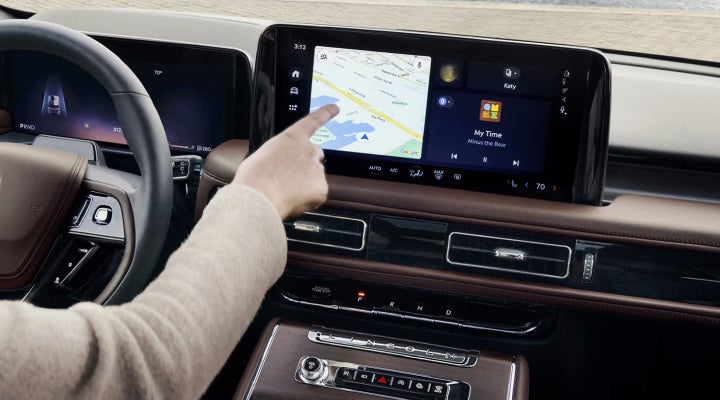 A person is tapping the center display touchscreen of a 2026 Lincoln Aviator® SUV. | Northgate Lincoln in Port Huron MI
