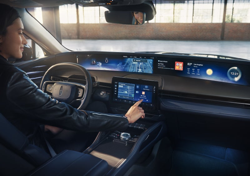 The driver of a 2026 Lincoln Nautilus® SUV interacts with the center touchscreen. | Northgate Lincoln in Port Huron MI