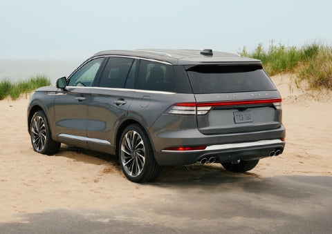 A 2027 Lincoln Aviator® SUV is parked next to sand dunes. | Northgate Lincoln in Port Huron MI