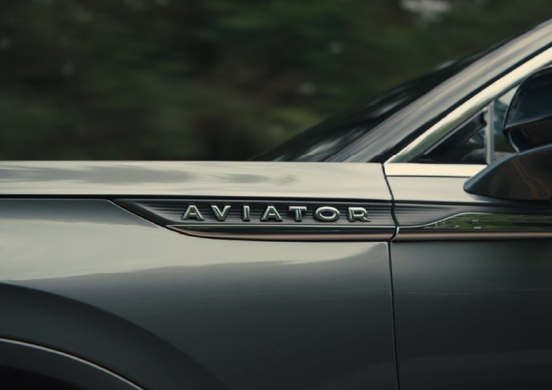 The driver’s side door and fender badging of a gray 2027 Lincoln Aviator® SUV are showcased. | Northgate Lincoln in Port Huron MI