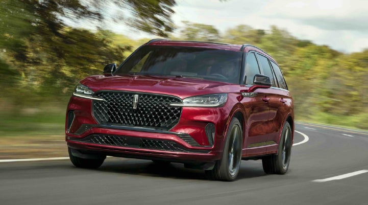 A 2027 Lincoln Aviator® SUV is being driven on a country road | Northgate Lincoln in Port Huron MI