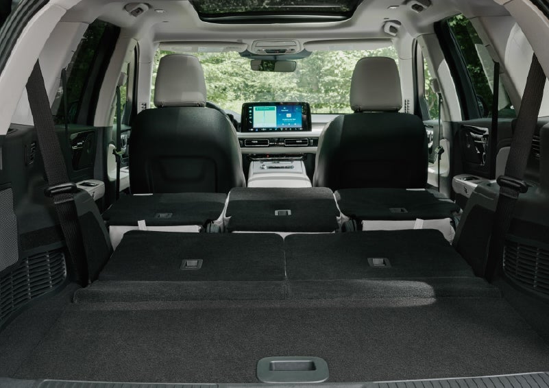 A rear to front view of the interior of a 2027 Lincoln Aviator® Black Label™ SUV shows the third and second rows folded flat | Northgate Lincoln in Port Huron MI