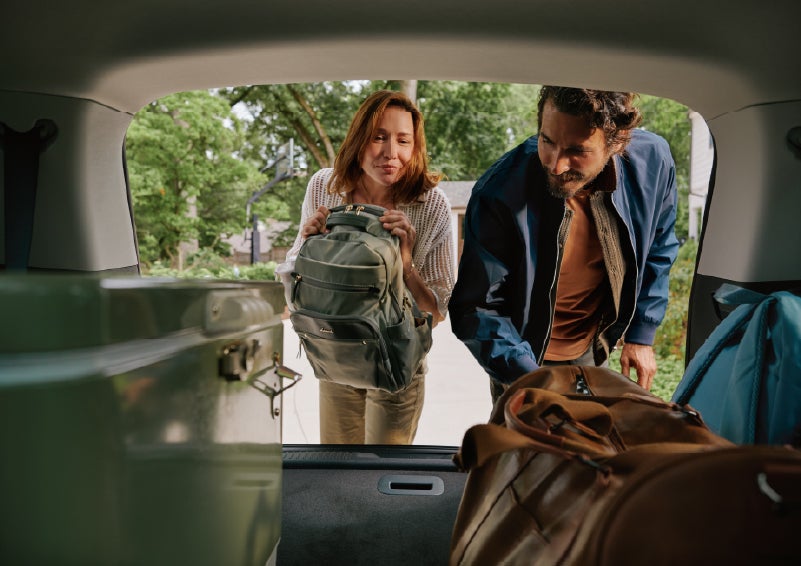 A couple loads luggage into the rear of a 2027 Lincoln Aviator® Black Label™ SUV..e 202 | Northgate Lincoln in Port Huron MI