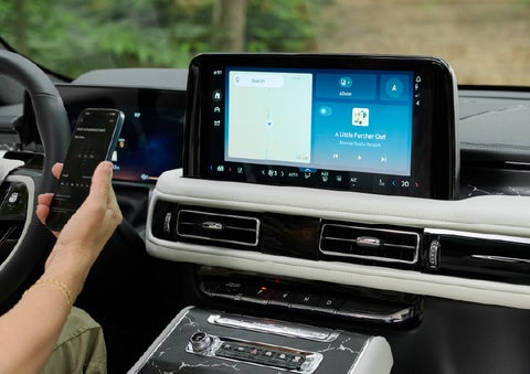 A person pairs thier phone with the center touchscreen of a 2027 Lincoln Aviator® Black Label™ SUV | Northgate Lincoln in Port Huron MI